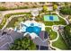 Expansive backyard featuring a large pool, lush greenery, tennis court, putting green, and multiple patio areas at 5040 N Arcadia Dr, Phoenix, AZ 85018