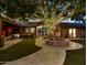 Picturesque backyard with a large tree adorned with lights, a water feature, and lush landscaping at 5040 N Arcadia Dr, Phoenix, AZ 85018