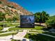 Spacious backyard featuring an outdoor movie screen, lush lawn, and mature trees, perfect for entertaining at 5040 N Arcadia Dr, Phoenix, AZ 85018