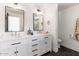 Sleek bathroom with dual sinks, modern fixtures, and contrasting dark hexagon tile flooring at 5040 N Arcadia Dr, Phoenix, AZ 85018