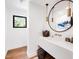 Modern bathroom featuring a stylish mirror, wood accents, and contemporary design elements at 5040 N Arcadia Dr, Phoenix, AZ 85018