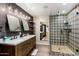 Modern bathroom with a double sink, decorative tile shower, and open shelving, creating a spa-like retreat at 5040 N Arcadia Dr, Phoenix, AZ 85018