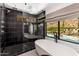 This luxurious bathroom features a shower, soaking tub, and a stunning view of the pool at 5040 N Arcadia Dr, Phoenix, AZ 85018