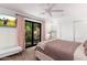 Bright bedroom with sliding glass doors to the yard, TV, neutral walls and modern furnishings at 5040 N Arcadia Dr, Phoenix, AZ 85018