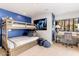 Cozy bedroom with a bunk bed, large TV, and a view of the mountains from a bright window at 5040 N Arcadia Dr, Phoenix, AZ 85018