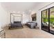Bright bedroom featuring a 4-poster bed, a stylish daybed, and access to an outdoor balcony at 5040 N Arcadia Dr, Phoenix, AZ 85018