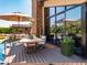 Spacious outdoor deck features a dining table with umbrellas and overlooks the pool and lush backyard at 5040 N Arcadia Dr, Phoenix, AZ 85018