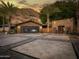 Stunning home exterior featuring desert landscaping and a stone facade against a mountain backdrop at 5040 N Arcadia Dr, Phoenix, AZ 85018