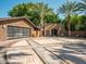 Spacious garage and parking area, framed by mature trees and lush landscaping, offering ample space at 5040 N Arcadia Dr, Phoenix, AZ 85018