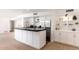 Modern kitchen with a large island, stainless steel appliances, and white cabinetry with stylish decor at 5040 N Arcadia Dr, Phoenix, AZ 85018