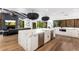 Modern kitchen and living room featuring marble countertops, a sleek fireplace, and open design at 5040 N Arcadia Dr, Phoenix, AZ 85018