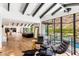 Spacious living area with beam ceilings, hardwood flooring and an adjacent outdoor space at 5040 N Arcadia Dr, Phoenix, AZ 85018