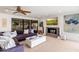 The cozy living room includes a large sofa, ceiling fan, and views of the outdoor living area at 5040 N Arcadia Dr, Phoenix, AZ 85018