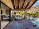 Covered patio features stone columns, an outdoor seating area, and views of the sparkling pool below at 5040 N Arcadia Dr, Phoenix, AZ 85018