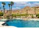 Expansive pool area with a cascading waterfall and lush desert landscaping and mountain views at 5040 N Arcadia Dr, Phoenix, AZ 85018