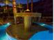 Unique pool with a built-in fire feature, palm trees, and serene lighting for evening enjoyment at 5040 N Arcadia Dr, Phoenix, AZ 85018
