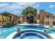 Luxury home's pool and backyard features a spa, in-water seating, and lush landscaping at 5040 N Arcadia Dr, Phoenix, AZ 85018