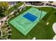 Aerial view of a well-maintained backyard tennis court with lush landscaping and green surroundings at 5040 N Arcadia Dr, Phoenix, AZ 85018