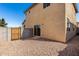 Home's backyard features a small area covered with rocks and a wooden gate in block wall at 5233 W Albeniz Pl, Phoenix, AZ 85043