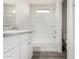 Bright bathroom featuring a shower-tub combo and granite countertops at 5233 W Albeniz Pl, Phoenix, AZ 85043