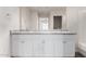 Bathroom featuring double sinks with granite countertops and white cabinets at 5233 W Albeniz Pl, Phoenix, AZ 85043