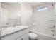 Bathroom featuring a granite countertop, a tub, and a small window at 5233 W Albeniz Pl, Phoenix, AZ 85043