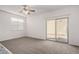Comfortable bedroom featuring plush carpeting, a sliding glass door, and bright natural light at 5233 W Albeniz Pl, Phoenix, AZ 85043