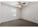 This bedroom features neutral walls, carpeted floors, and a window with blinds at 5233 W Albeniz Pl, Phoenix, AZ 85043