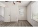 Carpeted bedroom with a window, ceiling fan, and a door to the hallway at 5233 W Albeniz Pl, Phoenix, AZ 85043