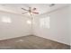 Bright bedroom featuring neutral carpeting, a ceiling fan and multiple windows at 5233 W Albeniz Pl, Phoenix, AZ 85043