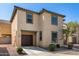 Two-story tan home with a two-car garage and a landscaped front yard at 5233 W Albeniz Pl, Phoenix, AZ 85043