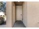 View of a white front door with a beige trim and matching textured walls at 5233 W Albeniz Pl, Phoenix, AZ 85043
