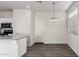 Eat-in kitchen featuring modern light fixture and an easy transition to dining space at 5233 W Albeniz Pl, Phoenix, AZ 85043
