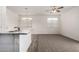 Well-lit kitchen area with a stylish breakfast bar featuring stone countertops and a convenient sink at 5233 W Albeniz Pl, Phoenix, AZ 85043