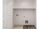 This is a basic laundry room with connections and neutral walls at 5233 W Albeniz Pl, Phoenix, AZ 85043