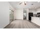 Bright living space boasts mixed flooring, a modern kitchen view, and a sliding glass door to the outdoors at 5233 W Albeniz Pl, Phoenix, AZ 85043