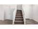 Carpeted staircase with white walls and railings leading to the upper level at 5233 W Albeniz Pl, Phoenix, AZ 85043