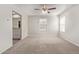 Bedroom with carpet, ceiling fan, and an ensuite bathroom at 5472 W Fulton St, Phoenix, AZ 85043
