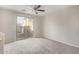 Carpeted bonus room offers natural light with backyard access through sliding glass doors at 5472 W Fulton St, Phoenix, AZ 85043