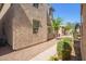 View of a two-story tan stucco townhome with desert landscaping at 5472 W Fulton St, Phoenix, AZ 85043