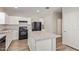 Spacious kitchen with a large island, modern appliances, and wood-look flooring at 5472 W Fulton St, Phoenix, AZ 85043