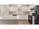 Kitchen featuring white cabinets, a black stove, and a granite countertop at 5472 W Fulton St, Phoenix, AZ 85043