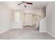 Bright living area with plush carpeting, large windows, and views of the staircase and entryway at 5472 W Fulton St, Phoenix, AZ 85043