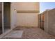 Enclosed patio features neutral stucco and gravel for low maintenance desert living at 5472 W Fulton St, Phoenix, AZ 85043