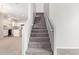 Carpeted staircase with white walls leads to upper level with natural lighting at 5472 W Fulton St, Phoenix, AZ 85043