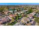 Expansive aerial view of a residential community featuring a scenic lake and well-maintained homes with terracotta roofs at 5670 W Linda Ln, Chandler, AZ 85226