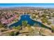 High angle aerial view capturing a lake surrounded by homes in a neighborhood with mature trees at 5670 W Linda Ln, Chandler, AZ 85226