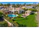 Aerial view of a home highlighting the pool, outdoor seating, lush lawn, and landscaped yard at 5670 W Linda Ln, Chandler, AZ 85226