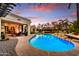 Stunning backyard with pool and dining area. Evening glow creates a peaceful retreat at 5670 W Linda Ln, Chandler, AZ 85226