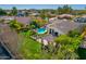 Aerial view of a private backyard featuring a sparkling pool, covered patio, lush lawn, and mature trees at 5670 W Linda Ln, Chandler, AZ 85226
